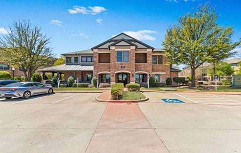 a large brick building with cars parked in front of it